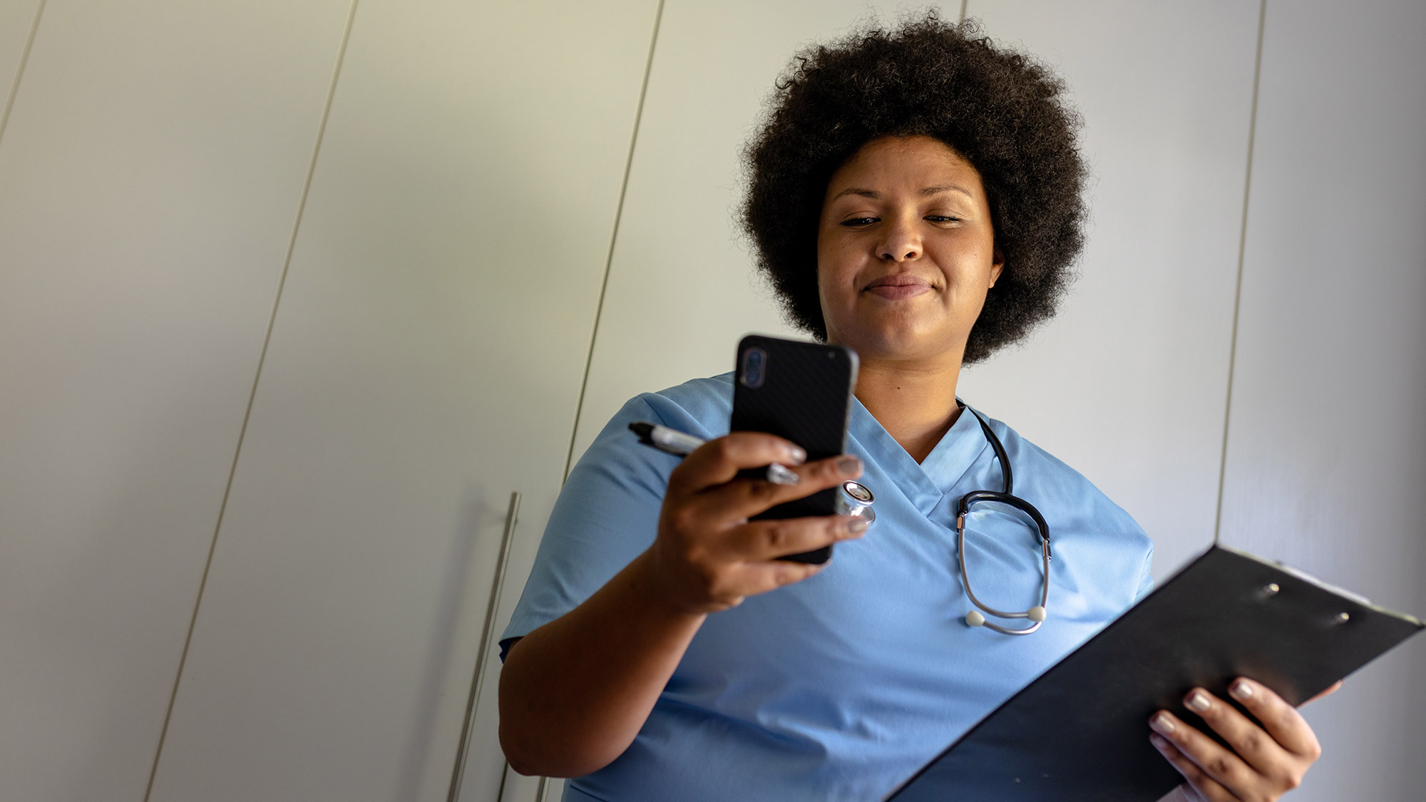 An NDIS worker using a personal mobile phone